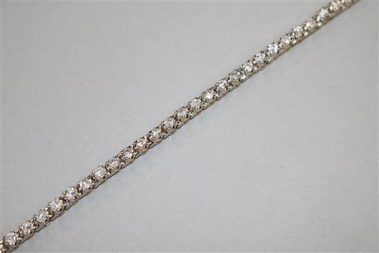 A modern 18ct white gold and diamond line bracelet, 18.5cm.